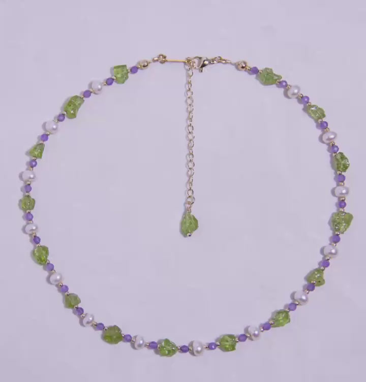 Handmade Peridot Amethyst Pearl necklace with 18K gold-plated adjustable chain, displayed in a circular design